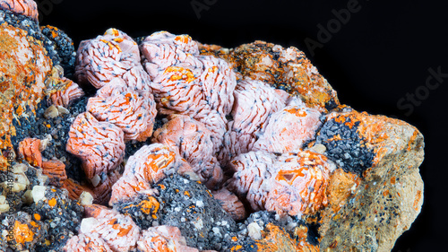 Beautiful detail of aragonite mineral stone isolated on black background. Closeup of white and orange crystal form of calcium carbonate. Mineralogy. Collectable item: Hridelec near Nova Paka, Czechia.