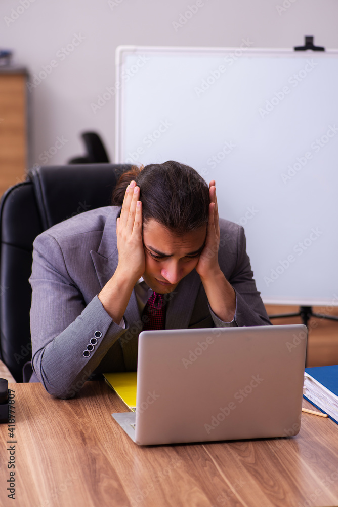 Young male business trainer in the office during pandemic Young male business trainer in the office during pandemic
