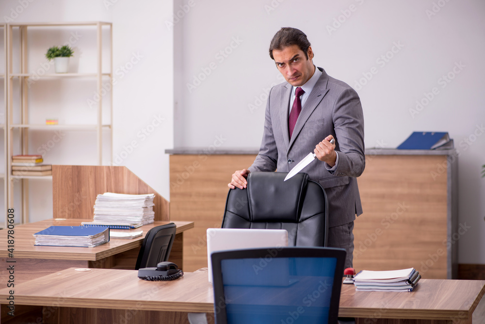 Fototapeta premium Young businessman employee in bullying concept in the office