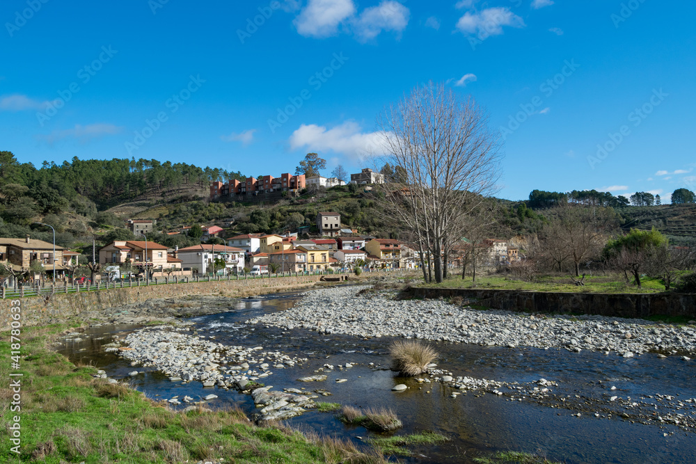 Views and landscape of the river and houses of the town of Nuñomoral.