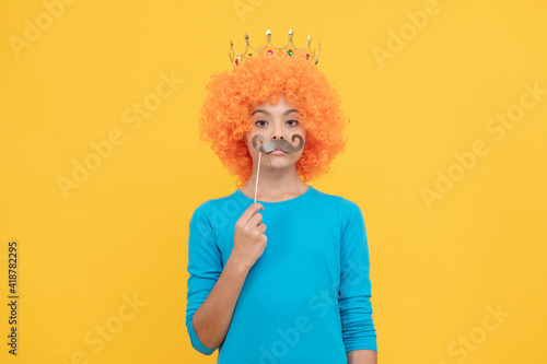 serious child wear diadem. teen girl in party moustache. being a clown. april fools day