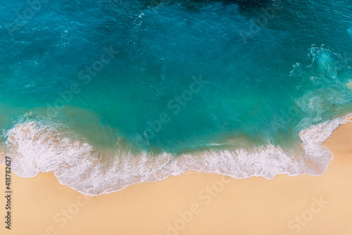 Kelingking beach, Nusa Penida, Indonesia. Beautiful beach and tropical sea. An empty tropical beach. Top view of the seascape. Ocean and sand. Copy space