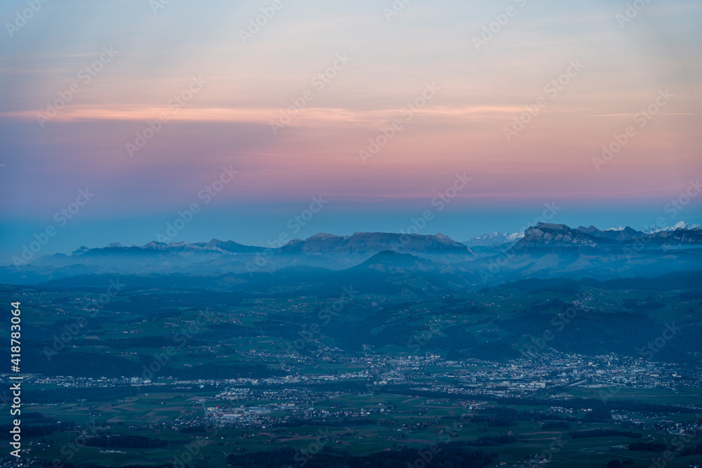 Fototapeta premium swiss mountains during sunset with fog and clouds and snowy mountains in the alps