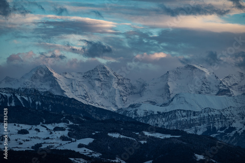 Fototapeta Naklejka Na Ścianę i Meble -  swiss mountains during sunset with fog and clouds and snowy mountains in the alps