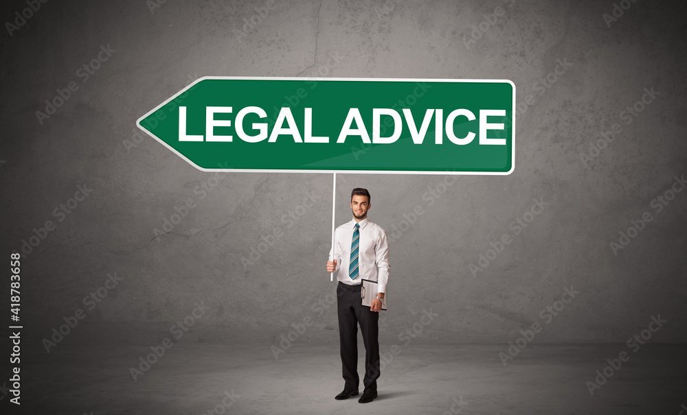 Young business person in casual holding road sign with LEGAL ADVICE inscription, new business direction concept Young business person in casual holding road sign with LEGAL ADVICE inscription, new business direction concept