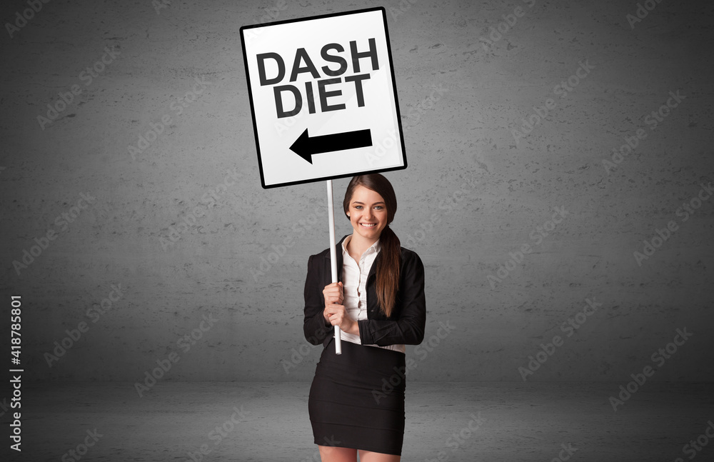 business person holding a traffic sign with DASH DIET inscription, new idea concept business person holding a traffic sign with DASH DIET inscription, new idea concept