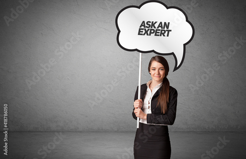 Young business person in casual holding road sign with ASK AN EXPERT inscription, new business idea concept