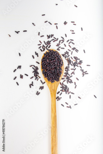 Black wild rice in a wooden spoon.