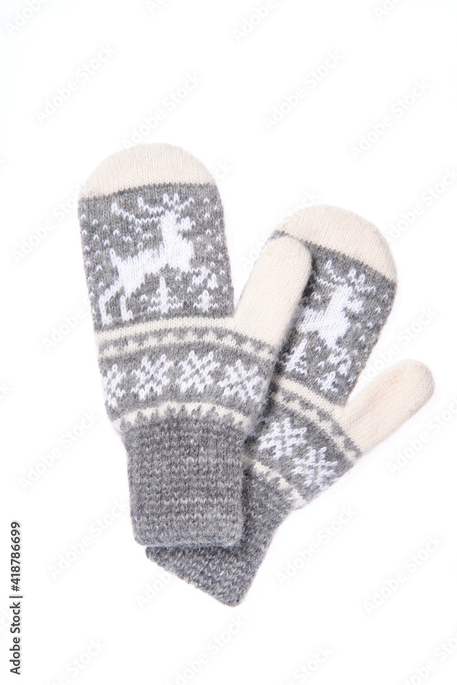 Warm woolen knitted mittens isolated on white background. Gray k Warm woolen knitted mittens isolated on white background. Gray k