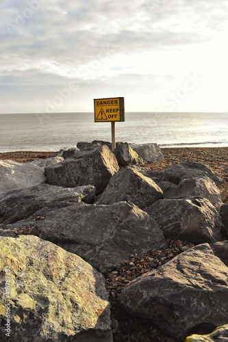 Rocks on the seaside. Sign Dangers Keep out. Horizon. Screen savers 