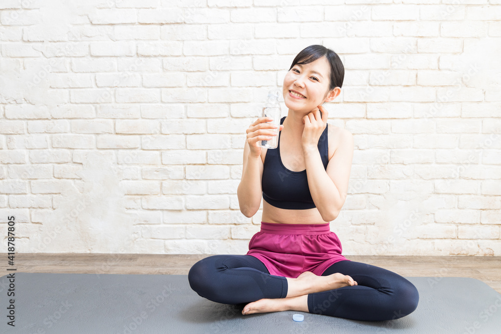 Woman drinking water after yoga