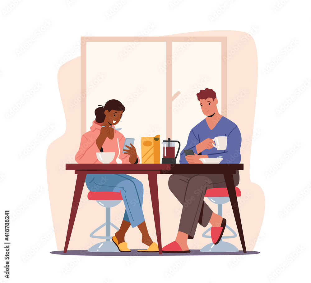 Couple Sitting at Table Having Breakfast with Smartphones in Hands. Young Man and Woman Relaxing at Home with Devices