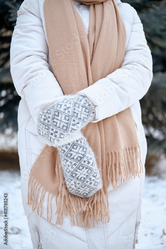 Hands in Knitted Mittens. Winter lifestyle. Wearing Stylish Warm