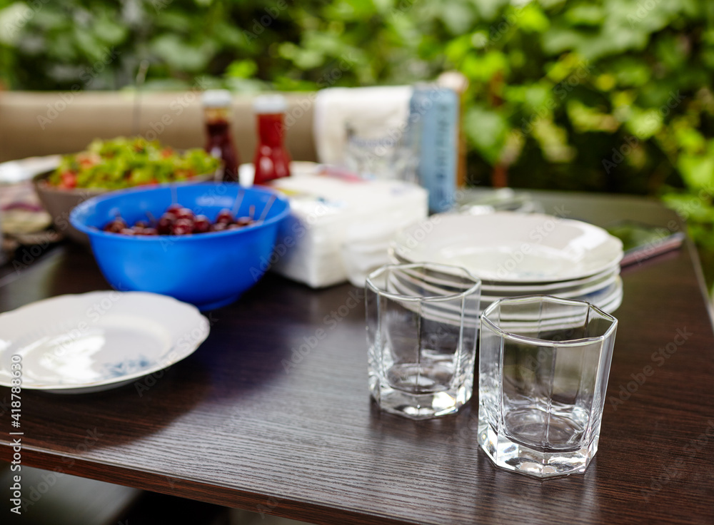 Blurry image of empty drink glasses on the table in outdoors restaurant Blurry image of empty drink glasses on the table in outdoors restaurant