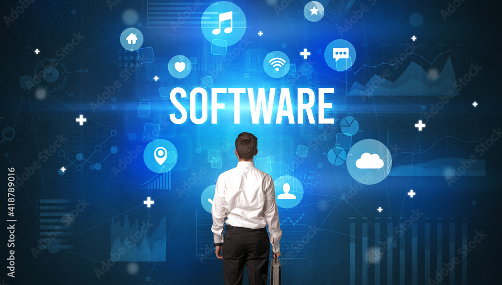 Rear view of a businessman with SOFTWARE inscription, modern technology concept Rear view of a businessman with SOFTWARE inscription, modern technology concept