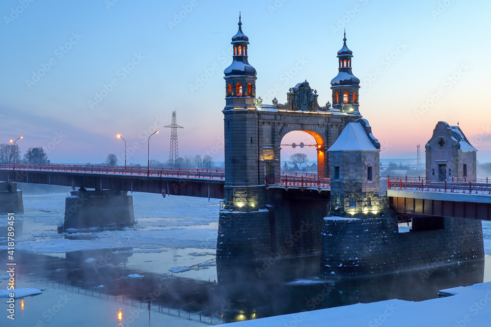 Winter ice drift on the European river Neman near the Queen Louise Bridge. Morning at dawn. Sovetsk Kaliningrad region