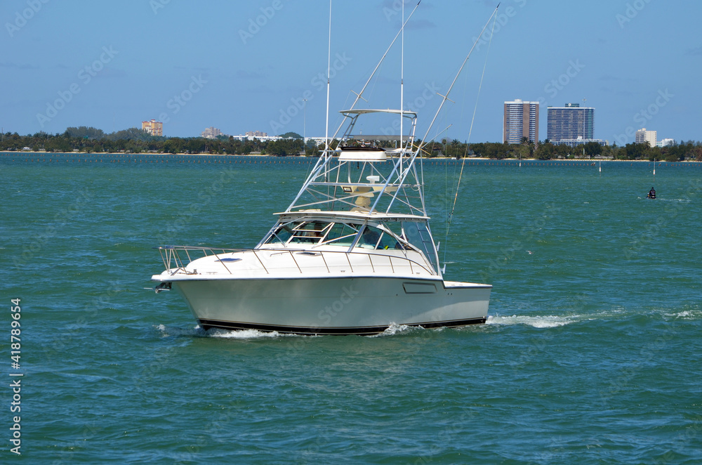 Fototapeta premium Sport fishing boat outfitted with a tuna tower cruising on the Florida intra-Coastal Waterway off of Miami Beach.