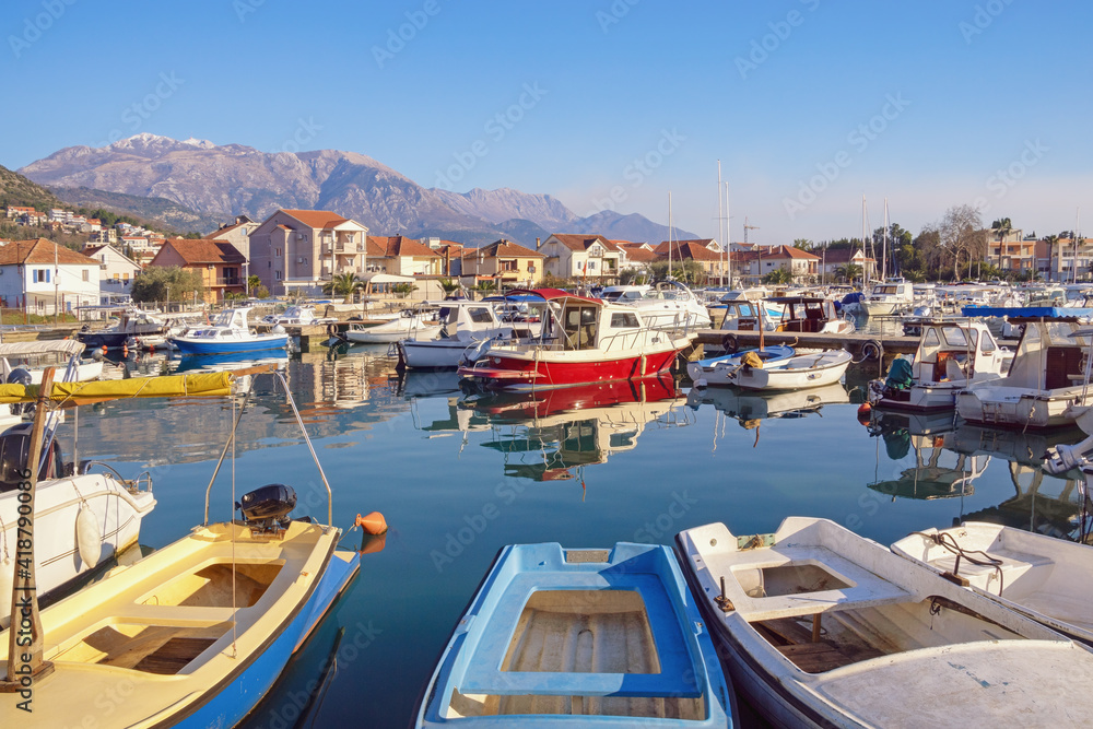 Beautiful Mediterranean landscape. Fishing boats in harbor. Montenegro,  Kotor Bay, Tivat city, view of marina Kalimanj