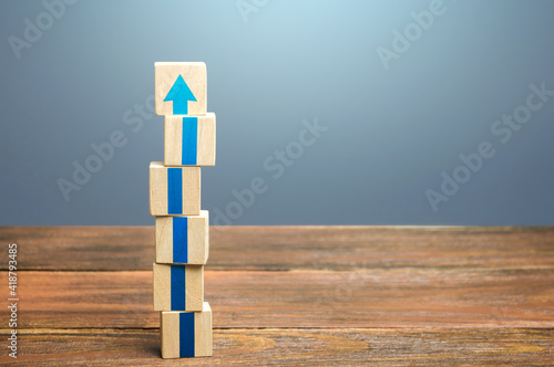 Block tower with blue arrows. Growth, development progress. Road map agreement concept. Career promotion step by step. Education, learning. Reaching a new level. Improving skills. Raising the standard