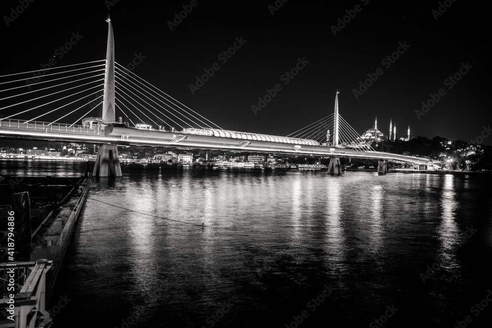 black and white photo of Golden Horn Bridge at night. Istanbul, Turkey