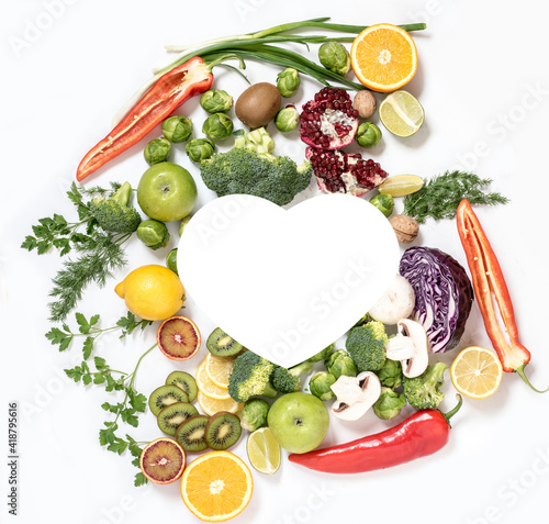 Healthy food composition with pure fruits. Place for text in the form of a heart. View from above. Flat lay.