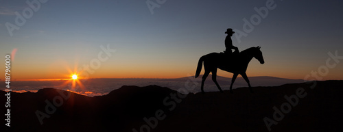 Sports girl riding a horse at countryside in a field, isolated image, black silhouette on a sunset background, against morning sky