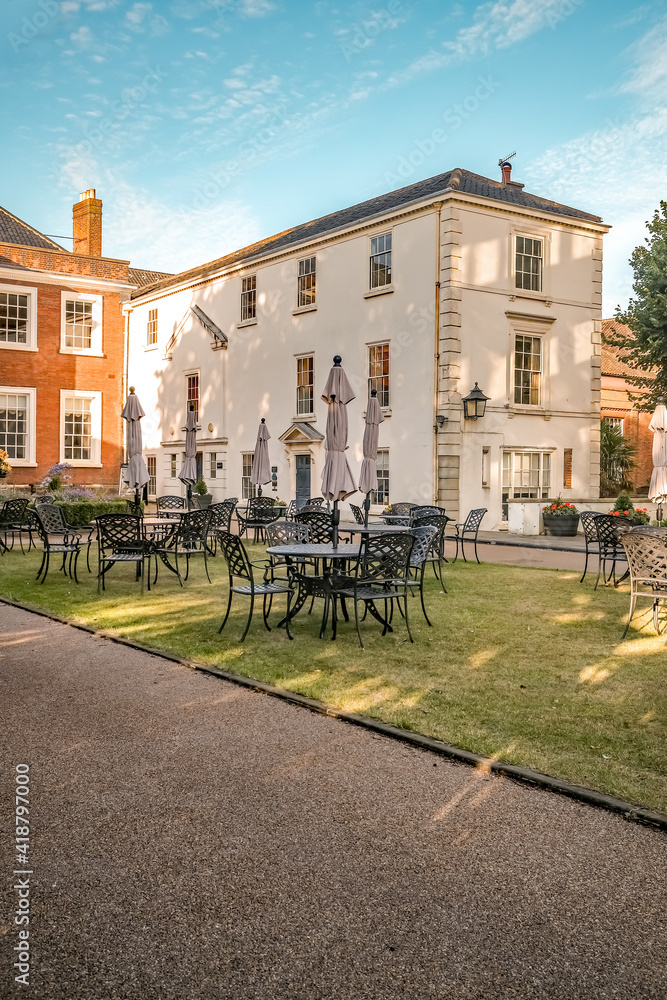 Outdoor tables, chairs and seating in the sunlit gardens of the Assembly Rooms in Norwich