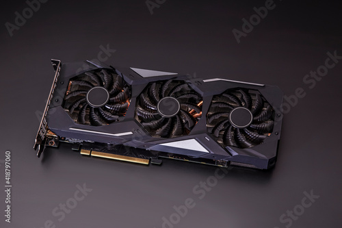 new graphics card on a black table with three cooling fans photo