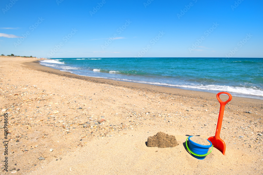 Toy bucket and shovel at the beach Toy bucket and shovel at the beach