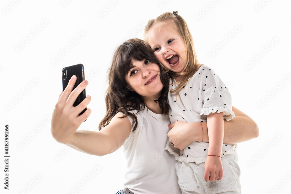 Happy woman and child taking a selfie isolated on white background Happy woman and child taking a selfie isolated on white background