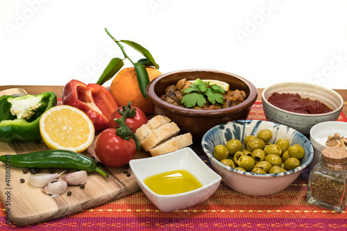 Mediterranean food - cooked meat, olives, yogurt, vegetables,  olive oil - on a wooden table and white background-2