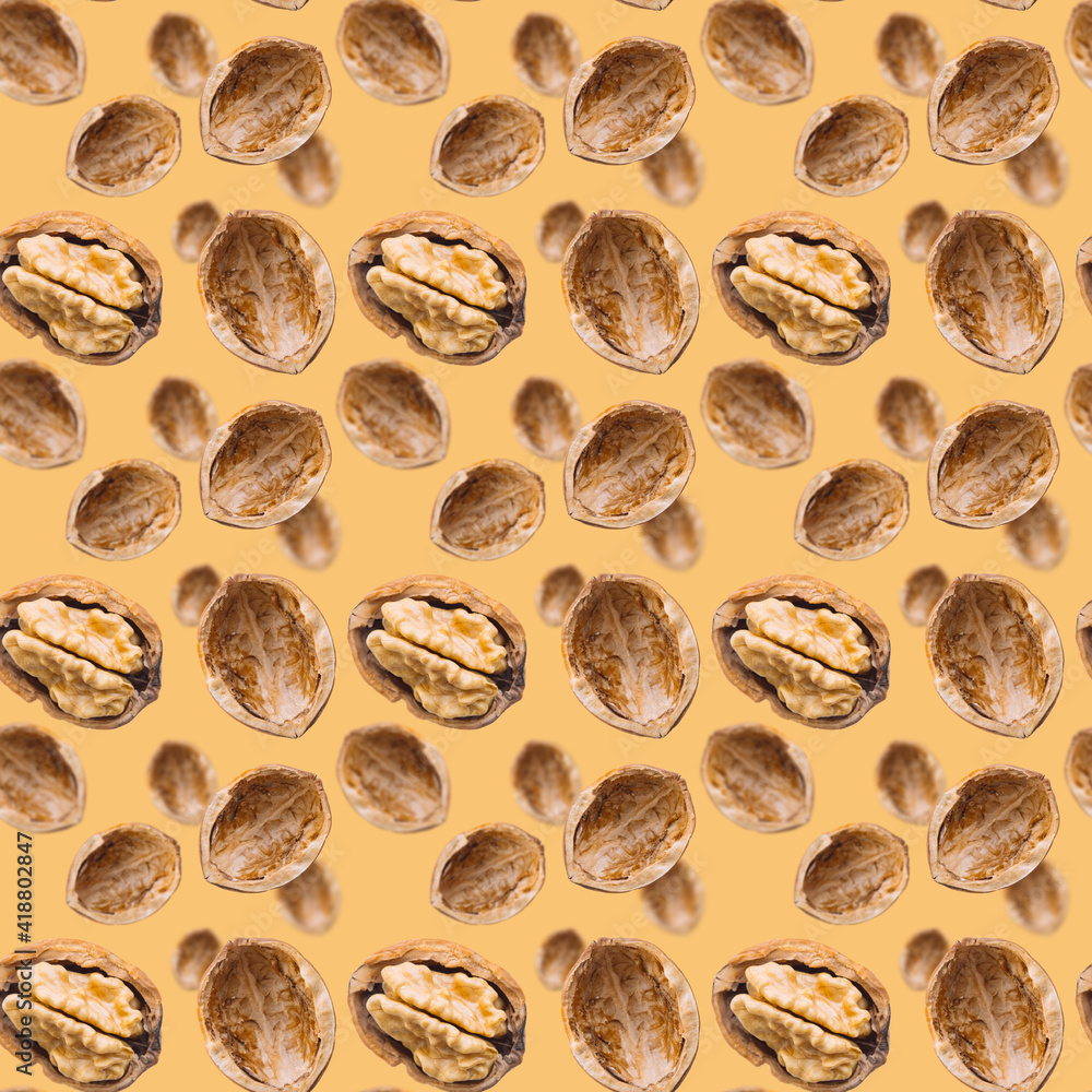 Walnut seamless pattern backdrop. Open nut shell and kernel on brown background. Top view of nuts. Banner. Pop art design Walnut seamless pattern backdrop. Open nut shell and kernel on brown background. Top view of nuts. Banner. Pop art design