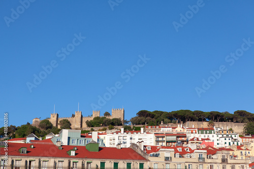 View of old town and hilltop castle in Lisbon . Castelo de S. Jorge situated on the mountain top in Lisboa Portugal