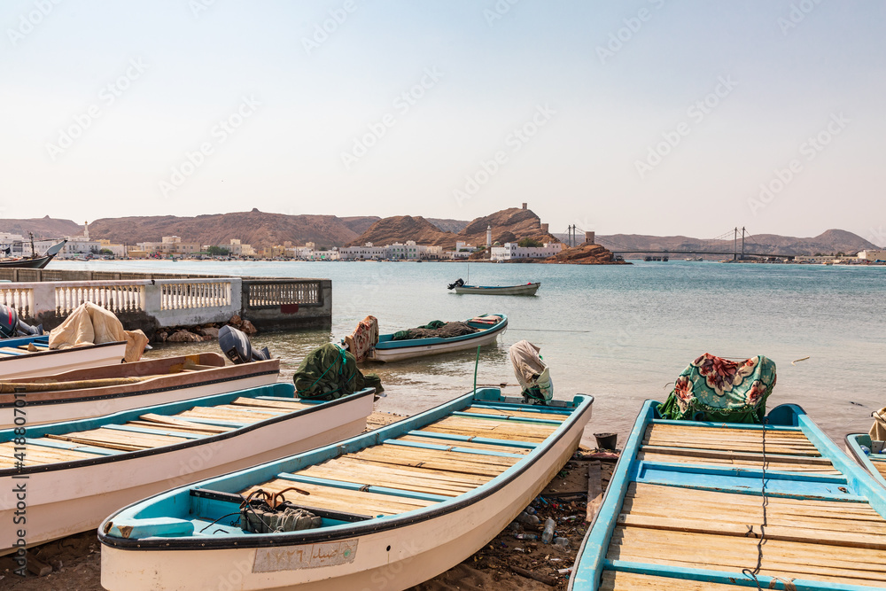 Fishing boats on the beach in the harbor of Sur, Oman.