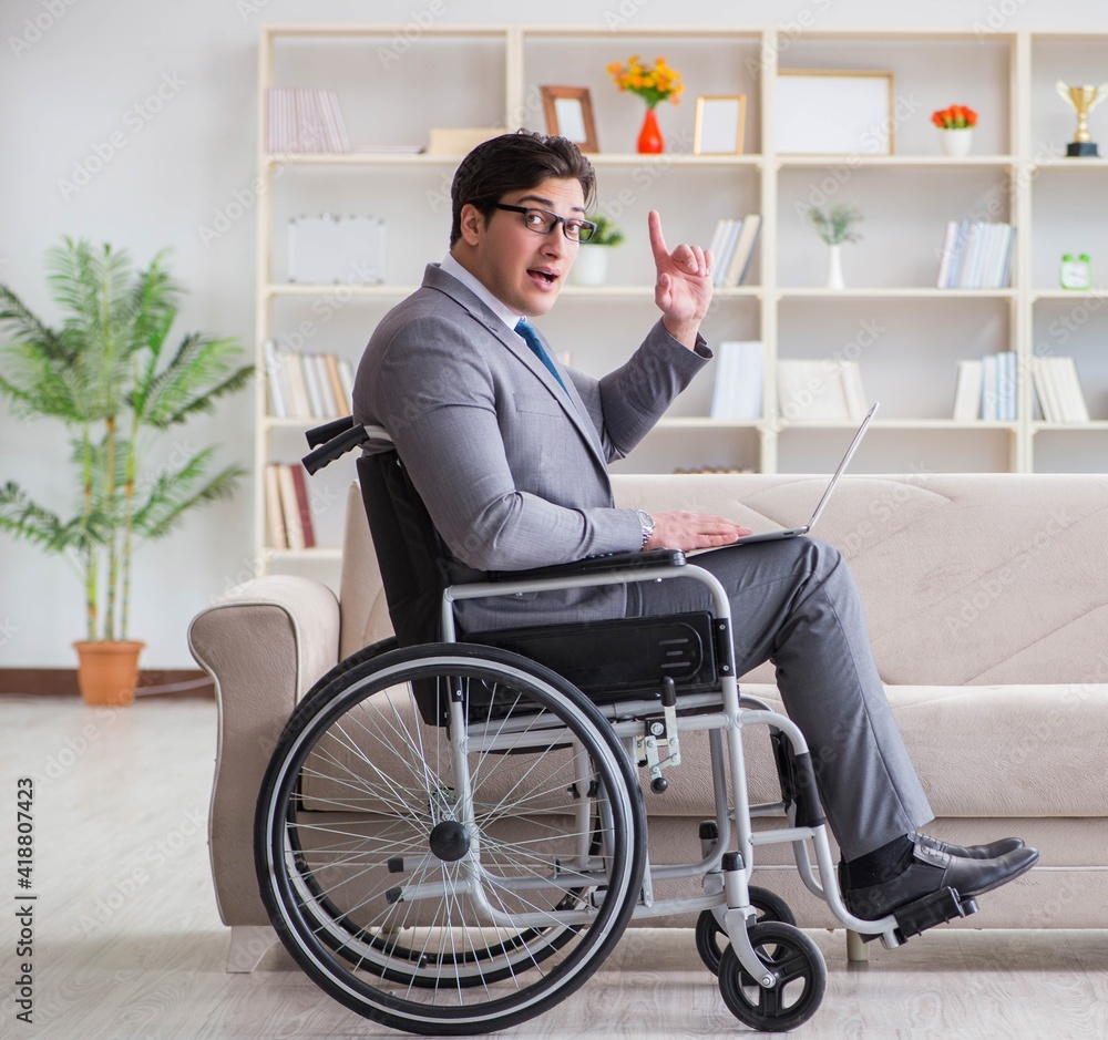 Dsabled businessman on wheelchair working home Dsabled businessman on wheelchair working home