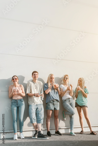 Group of young people, friends hanging together and laughing