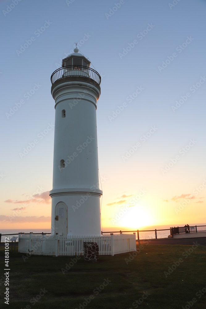 View of a light house with sunrise as background