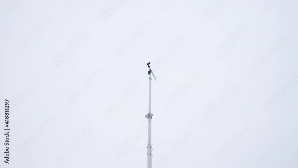 Wind Vane Blown By Wind Against Dramatic Sky. low angle Wind Vane Blown By Wind Against Dramatic Sky. low angle