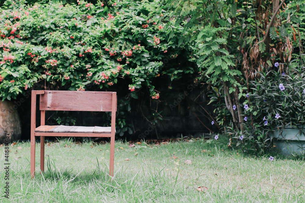 Antique wooden chair in green garden at summer day. For background. Antique wooden chair in green garden at summer day. For background.