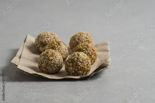 Energy balls on craft paper on tgray background photo