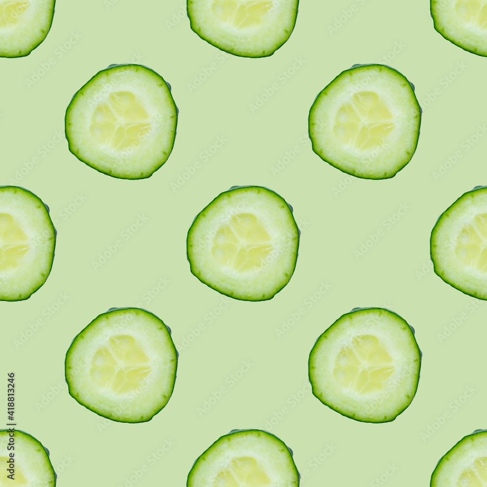 Seamless colourful pattern of fresh cucumber slices isolated on green background. Top view. Flat lay composition. Pop art design. Food or vegetable background Seamless colourful pattern of fresh cucumber slices isolated on green background. Top view. Flat lay composition. Pop art design. Food or vegetable background