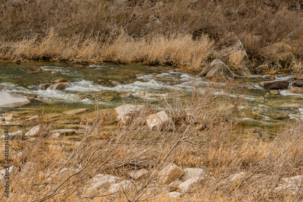 Water in river flowing over large rocks. Water in river flowing over large rocks.