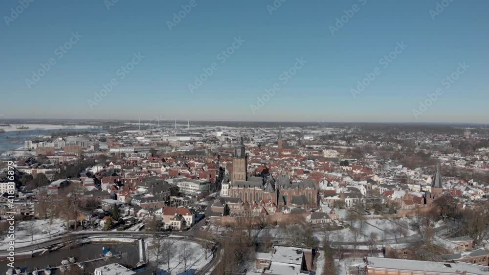 Medieval Hanseatic Dutch tower town Zutphen in the Netherlands covered in snow with historic heritage buildings and river IJssel passing by in the background seen from above Medieval Hanseatic Dutch tower town Zutphen in the Netherlands covered in snow with historic heritage buildings and river IJssel passing by in the background seen from above