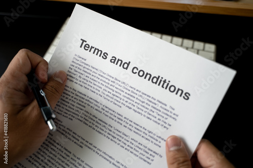 Terms and conditions businessman reviewing terms and conditions of agreement office terms and conditions