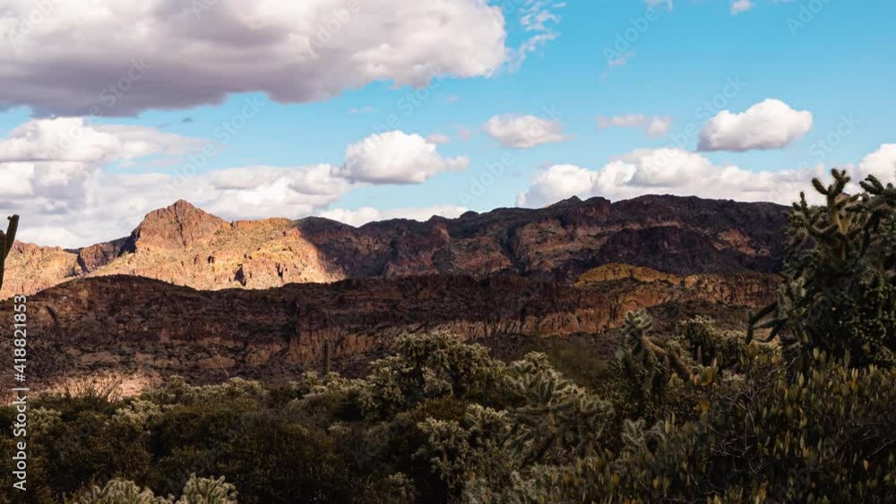 Massive storm clouds fly over canyons in the cactus-filled desert Massive storm clouds fly over canyons in the cactus-filled desert