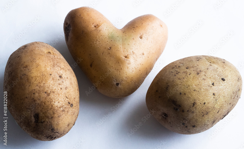 heart-shaped potatoes. wood texture. background old panels heart-shaped potatoes. wood texture. background old panels