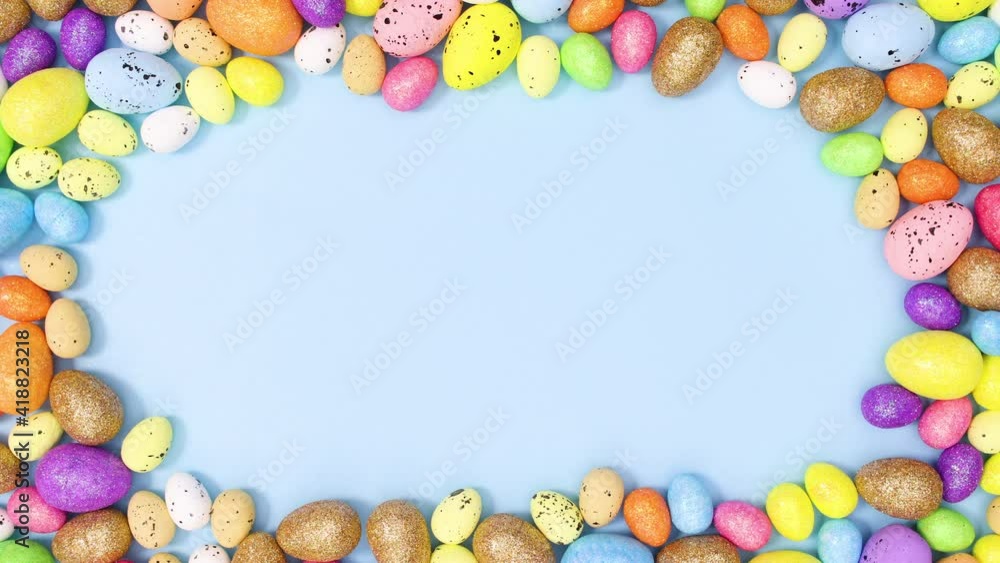 Colorful Easter eggs make copy space frame on pastel blue background. Stop motion Colorful Easter eggs make copy space frame on pastel blue background. Stop motion