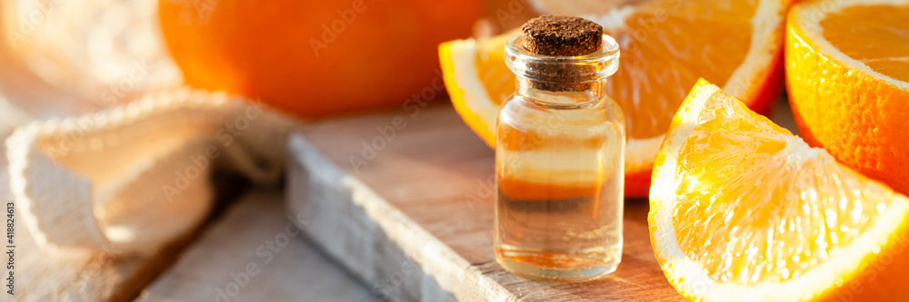 Concept of natural organic orange essential oil for skin face and body care. Moisturizing, aromatherapy, detox treatment, anti-stress effect. White wooden background, copy space for text, banner Concept of natural organic orange essential oil for skin face and body care. Moisturizing, aromatherapy, detox treatment, anti-stress effect. White wooden background, copy space for text, banner