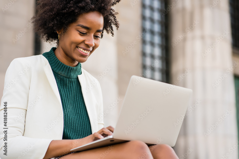 Business woman using her laptop outdoors. Business woman using her laptop outdoors.