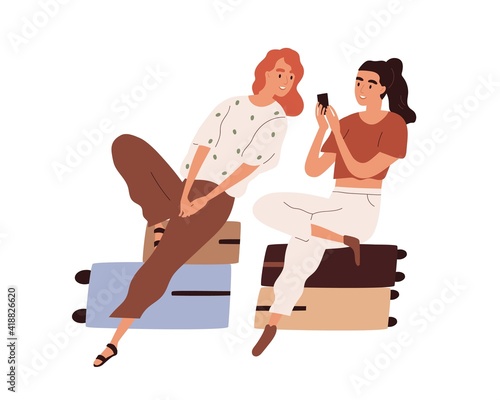 Couple of tourists with luggage waiting for flight. Passengers sitting on suitcases and looking photos in mobile phone. Colored flat cartoon vector illustration of women isolated on white background